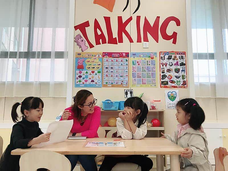 A teacher does an ESL speaking activity with young learners