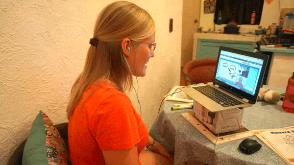 Young girl teaching English online.