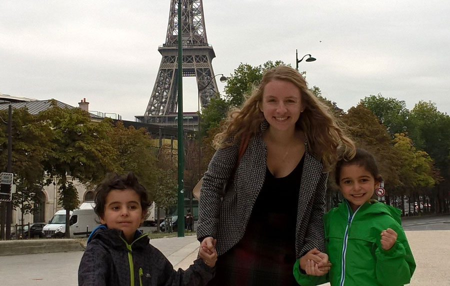 Camille, a South American TEFL teacher, with her students in front of the Eiffel Tower.