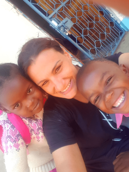 Lindsay with 2 of her ESL students in Tanzania 