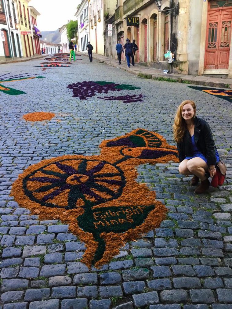 Maggie, an English teacher in Brazil posing with some street art. 