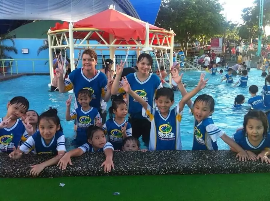 Educators with a group of young learners in a pool party activity.