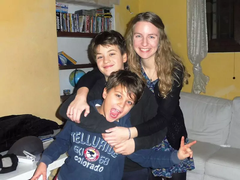 An image of a Bridge TEFL graduate, Camille, with two of her students teaching English in Italy