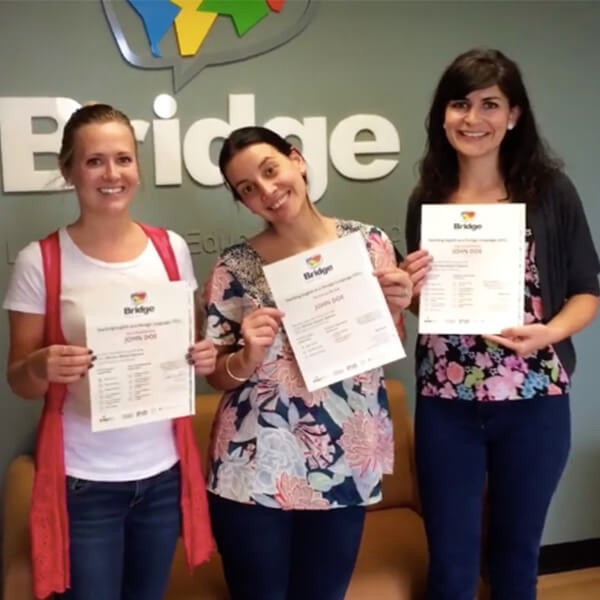 TEFL Certified English Teachers with certificates showing they met their 120 hour goals.