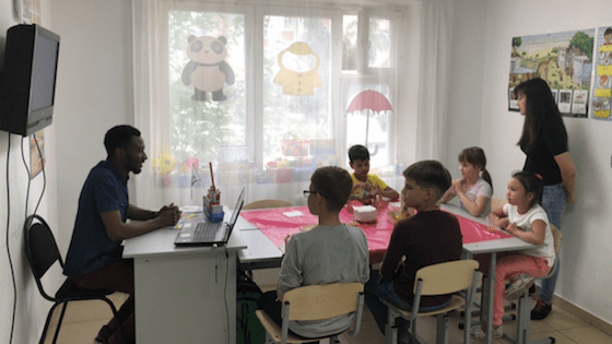 Tariq Adams, a BridgeTEFL graduate from Ghana, teaching a class of English students in Russia