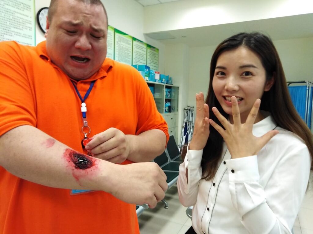 teacher with a fake makeup wound on his arm
