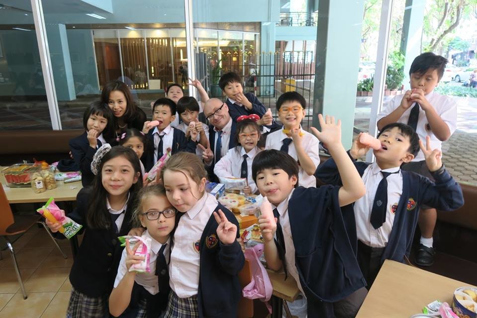 teacher with students at lunch