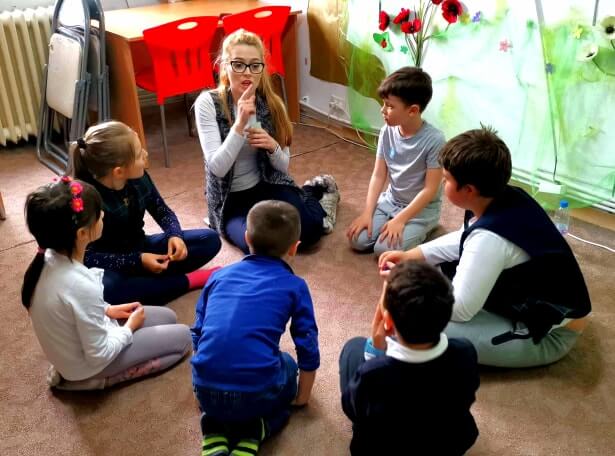 Young ESL students playing a group game in the classroom