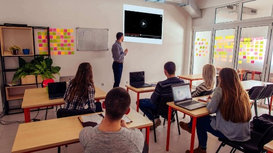 teacher showing video to students