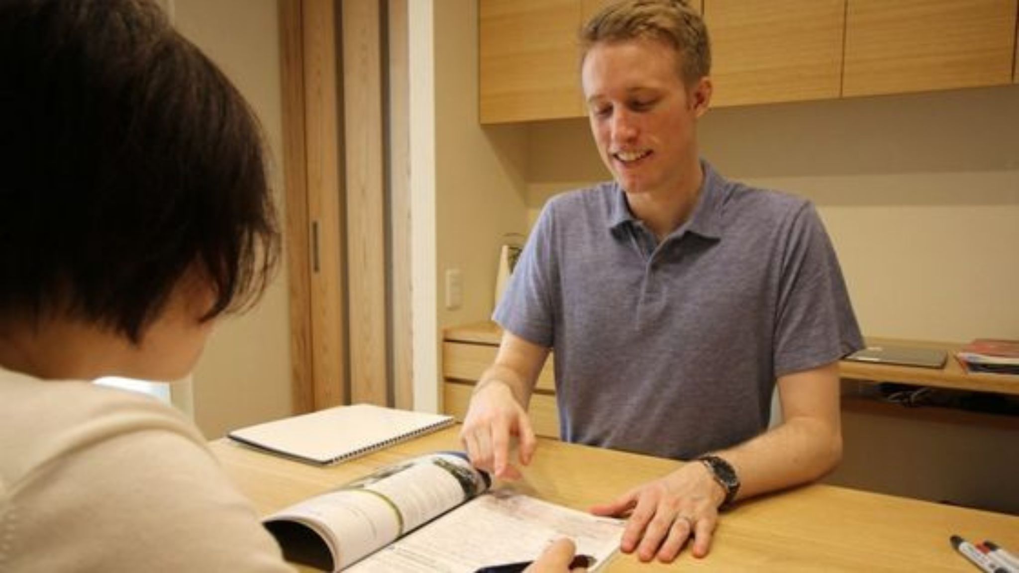 An image of an independent English teacher having a private in-person class with a student