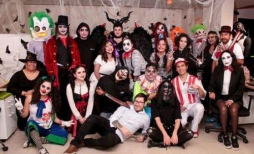 Vinicius poses with his students at a Halloween event.