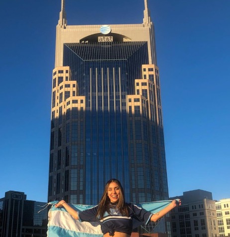 Female teacher holding Argentinian flag in Nashville