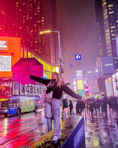 Young teacher in rainy New York City