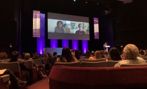 IATEFL speakers are projected on screen in front of audience, sharing recorded presentations.