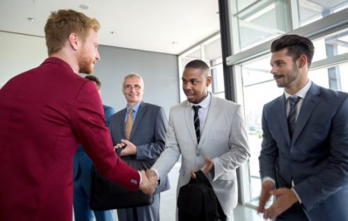 businessmen shake hands during an introduction.