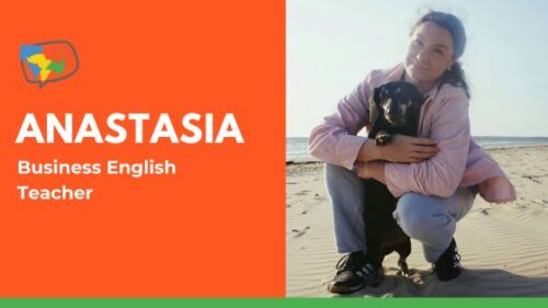 Business English teacher Anastasia hugs her dog at the beach.