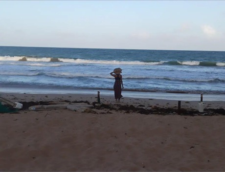 Shemmiah standing on the shore at the beach.