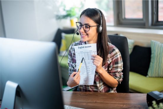 an online English teacher showing a lesson to a student.