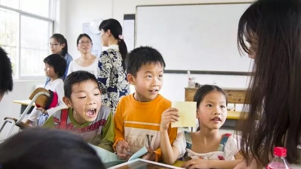 young students interact with their teacher