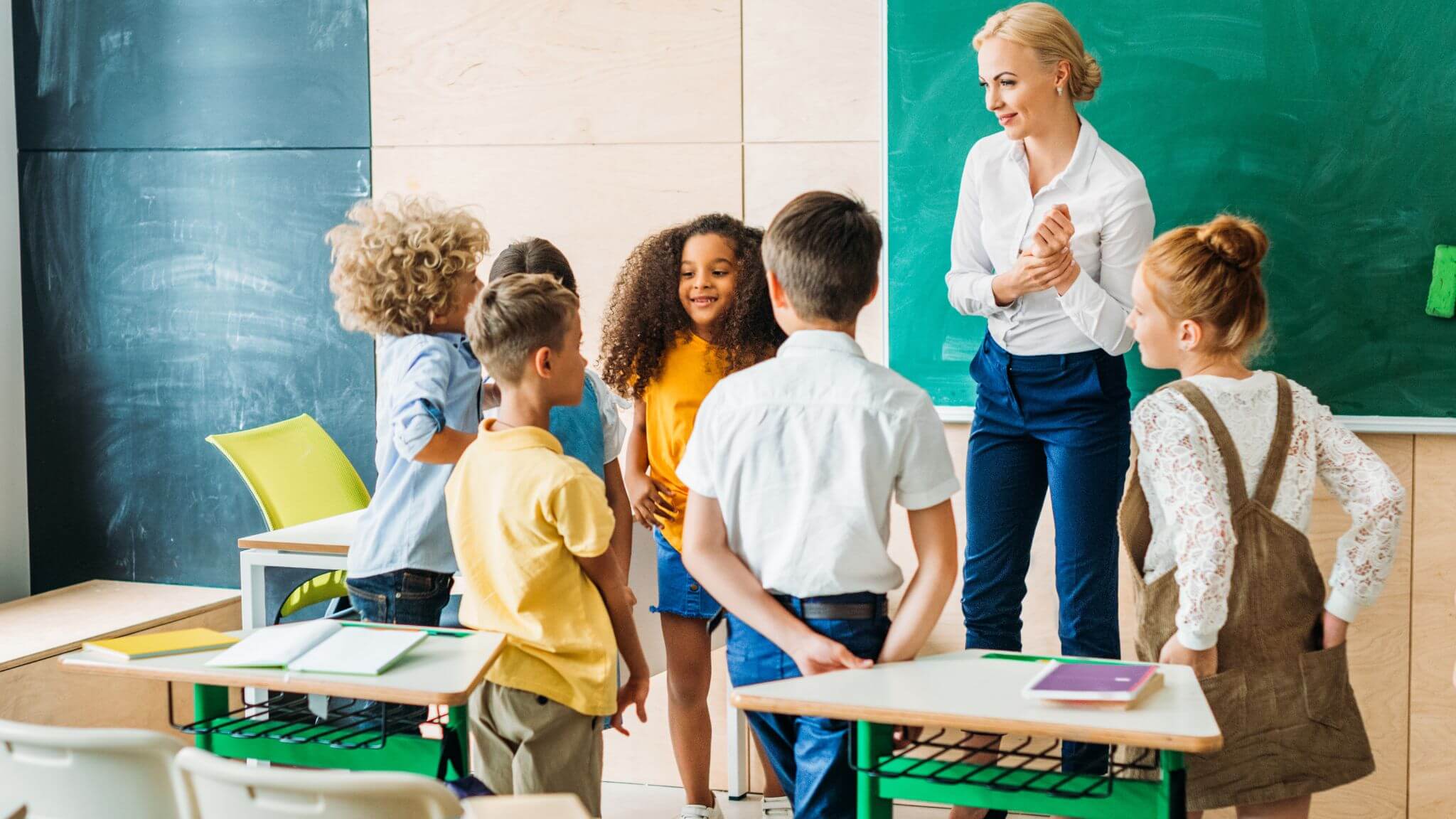 a teacher playing a grammar game with young students.