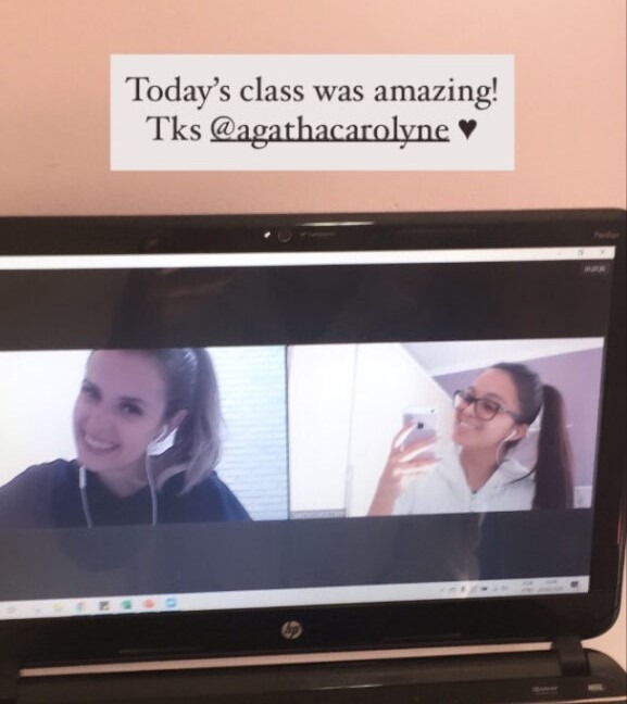 a laptop screen showing Carol and one of her students.