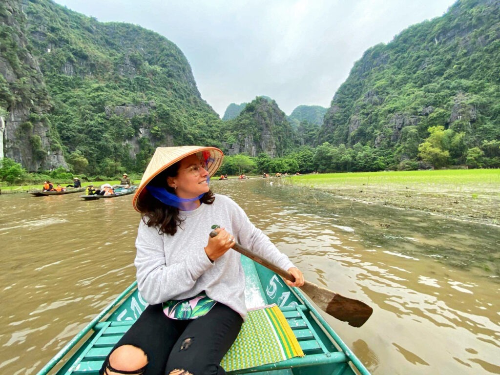 Roberta paddling in a canoe in Thailand.