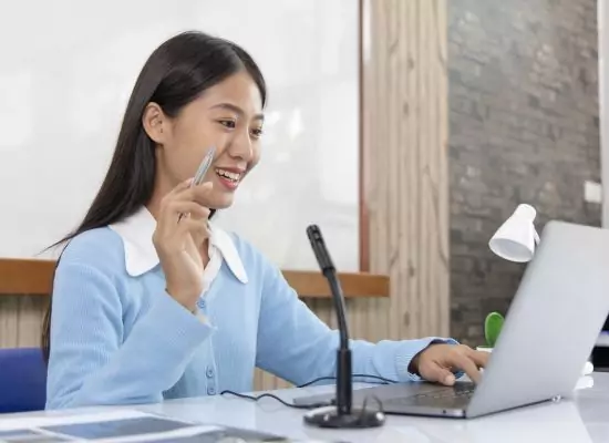 a teacher smiles at her students during as they play an online ESL game for teens.
