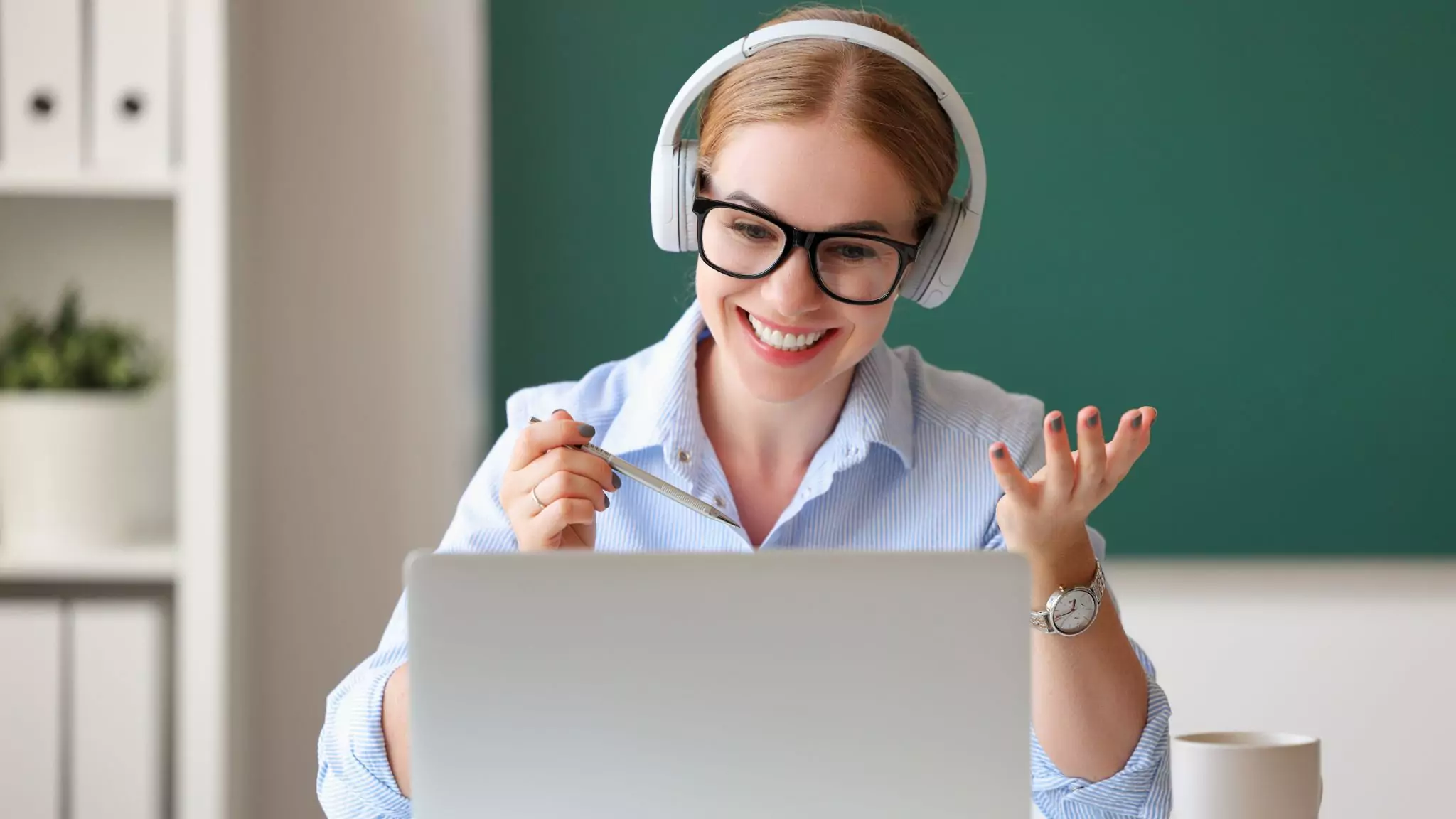 a teacher smiling at her laptop