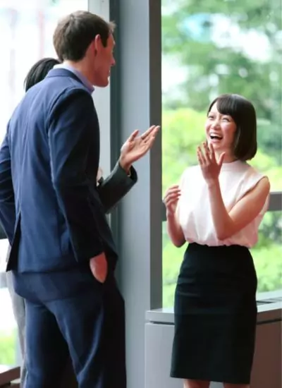 three people talking and laughing after a business meeting