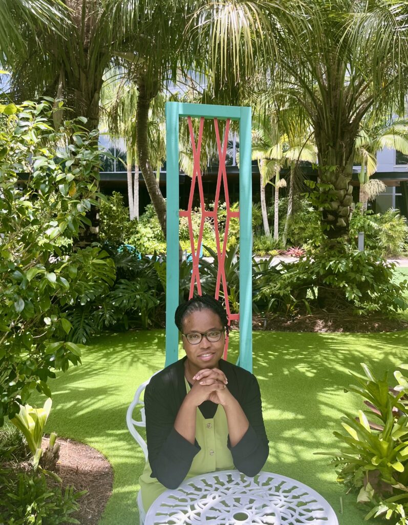 Simone sitting outdoors in a garden