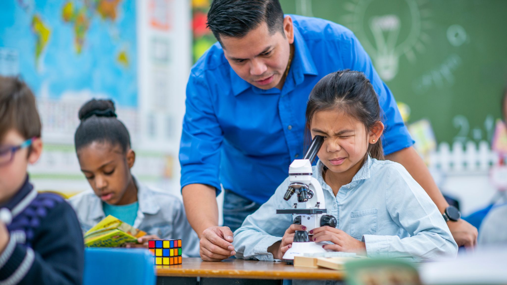 teacher working with student in CLIL science class