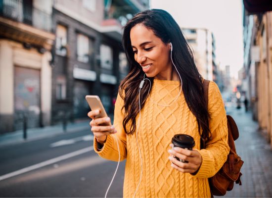 a woman listening to language lessons on her phone