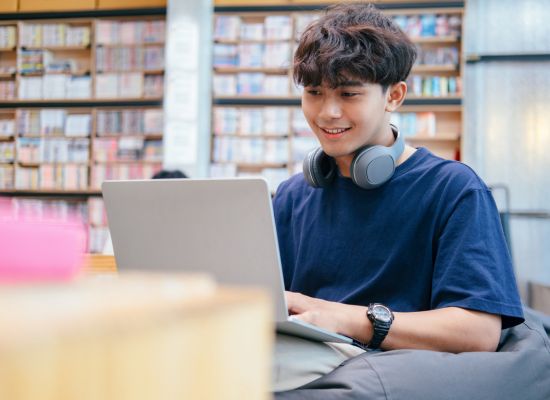 a teen student working on a laptop