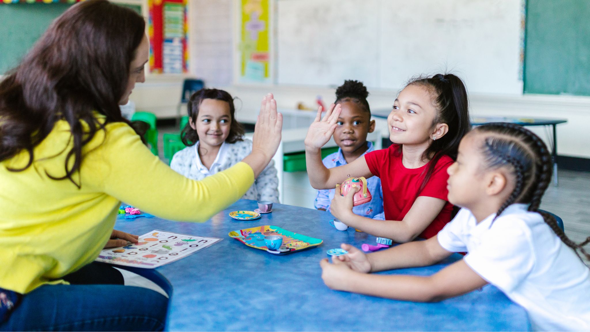 a teacher giving a young student a high five