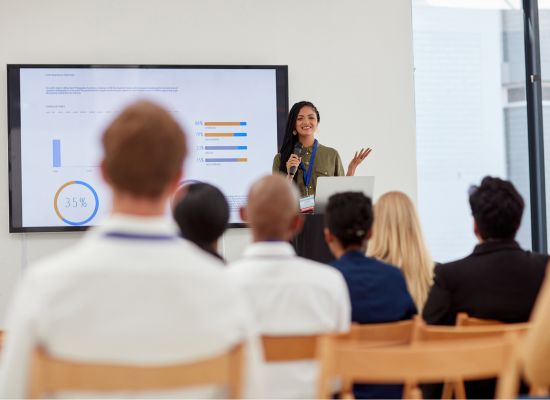 a woman presenting data in a conference room