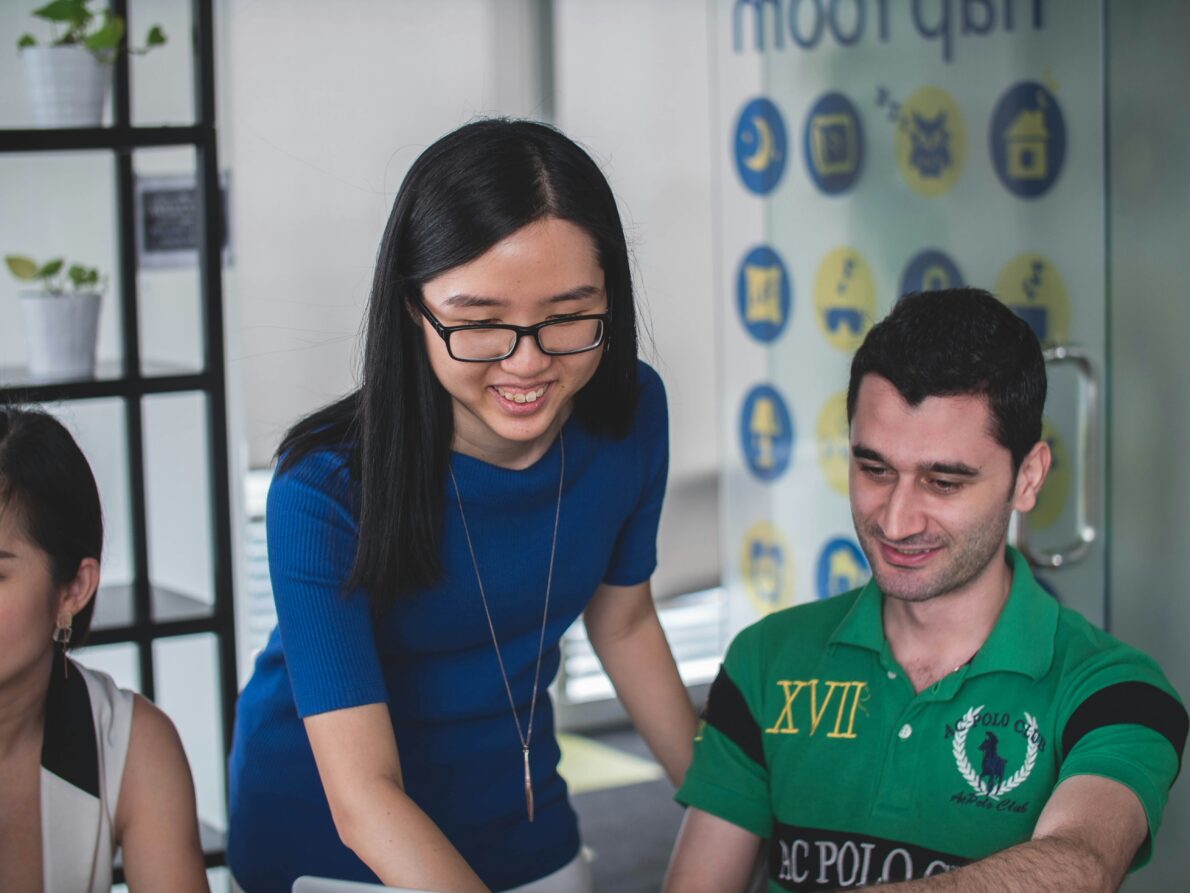 An image of a teacher helping a student in the classroom.