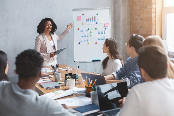 An image of a marketing professional giving a presentation in a business meeting