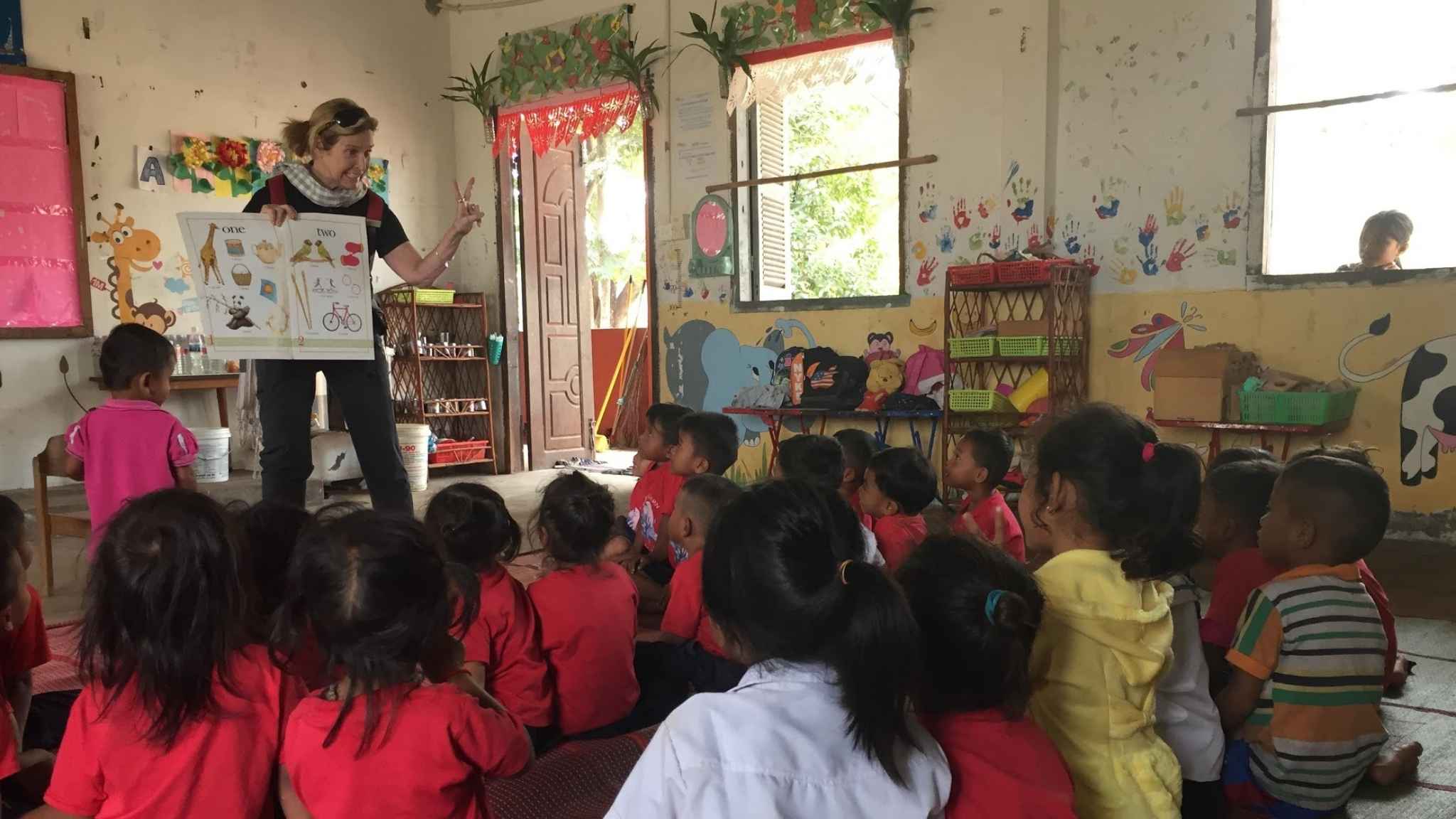 An image of an ESL teacher teaching English to kids in Cambodia