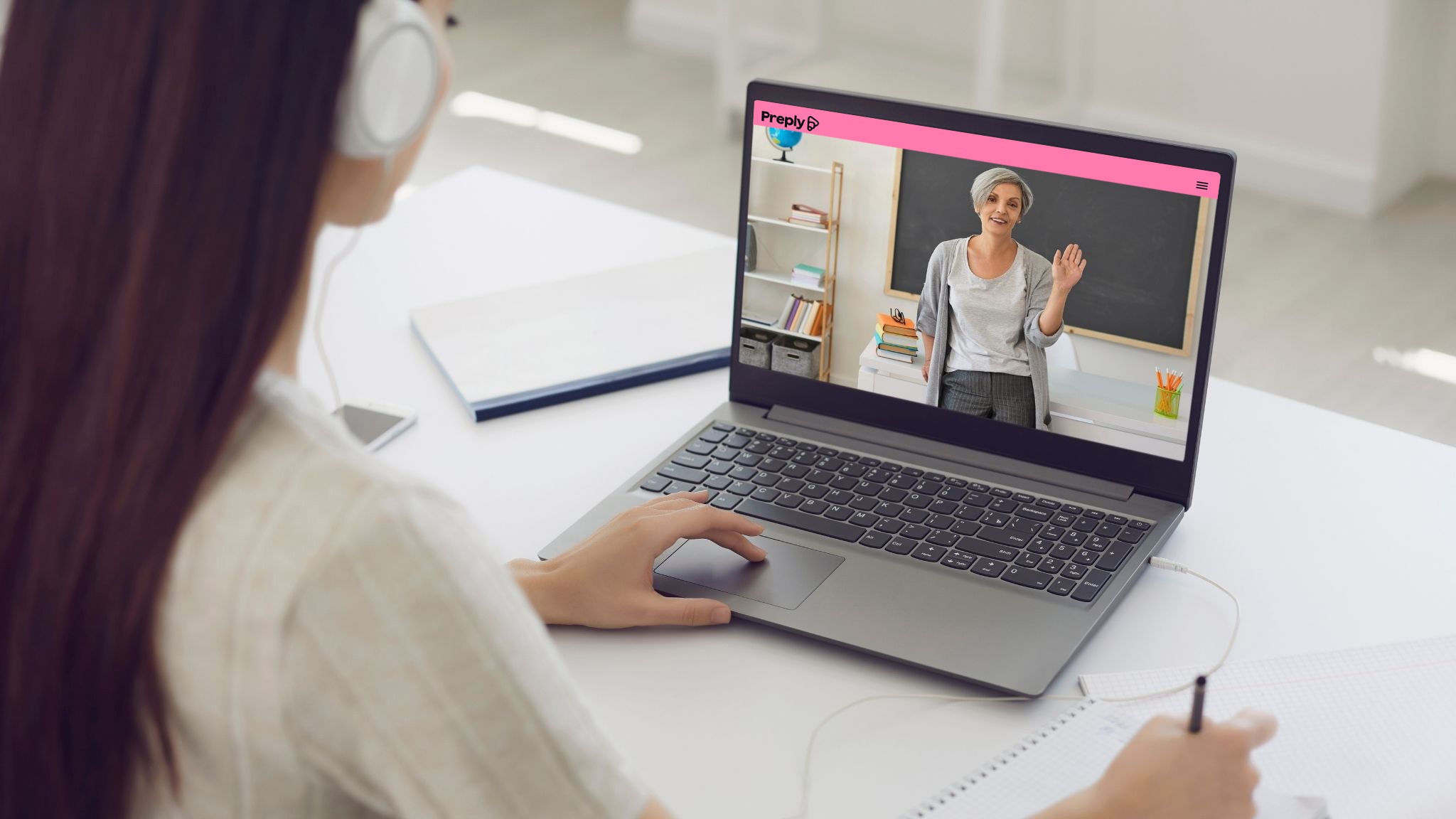 An image of a student looking at their English teacher on the screen of a laptop