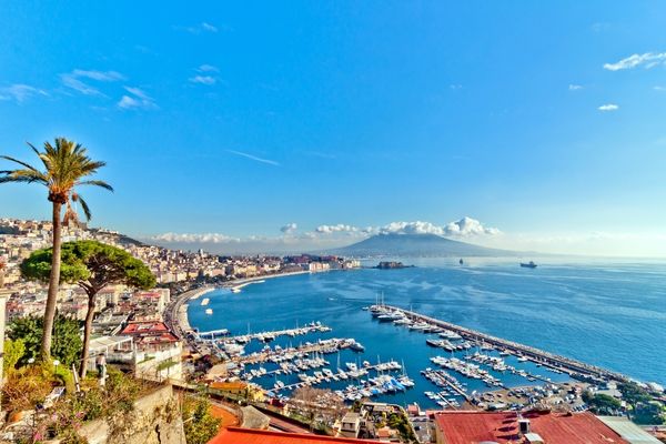 An image of Naples, Italy looking over the water to a volcano in the distance