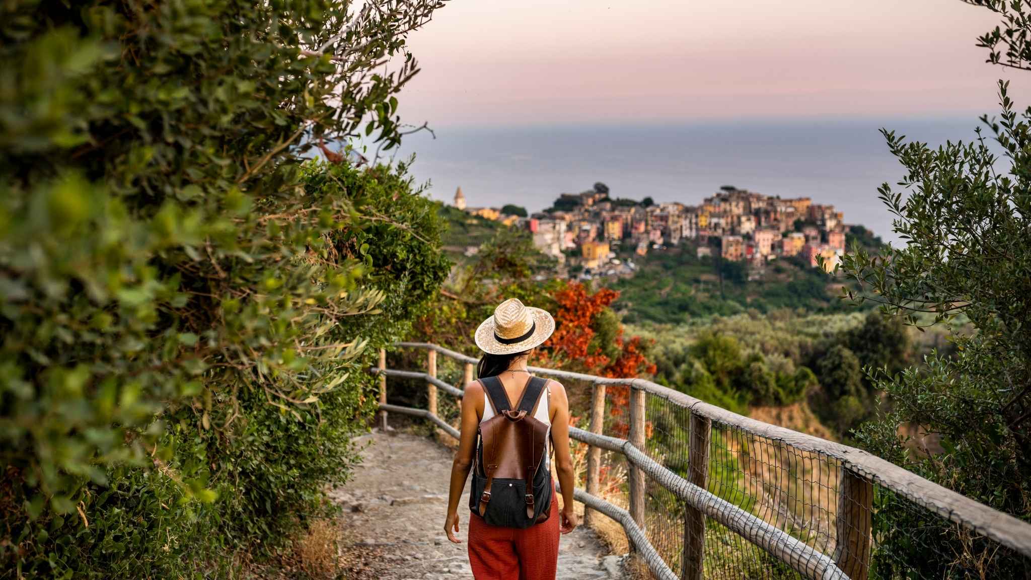 An image of an English teacher hiking in Cinque Terre looking at the village of Corniglia