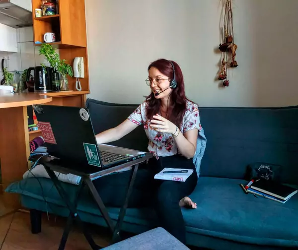 Teacher vesela teaching an online lesson from her couch.