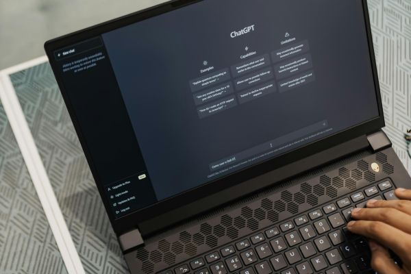 An image of a laptop showing the ChatGPT homepage