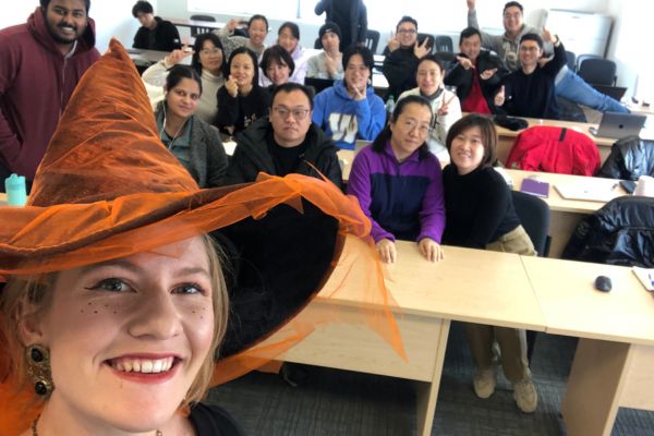 An image of a Bridge Teacherpreneur Academy smiling with a group of her English students in a classroom