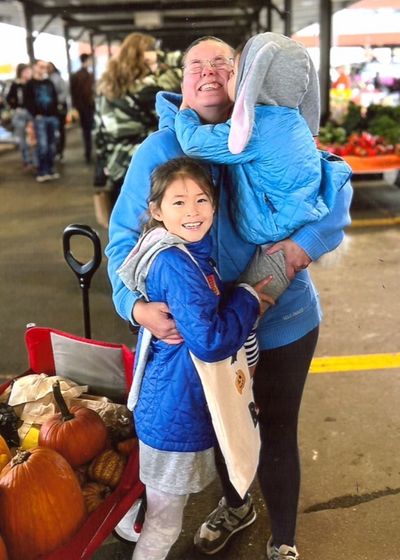 Joanna is greeted by the kids from her host family.