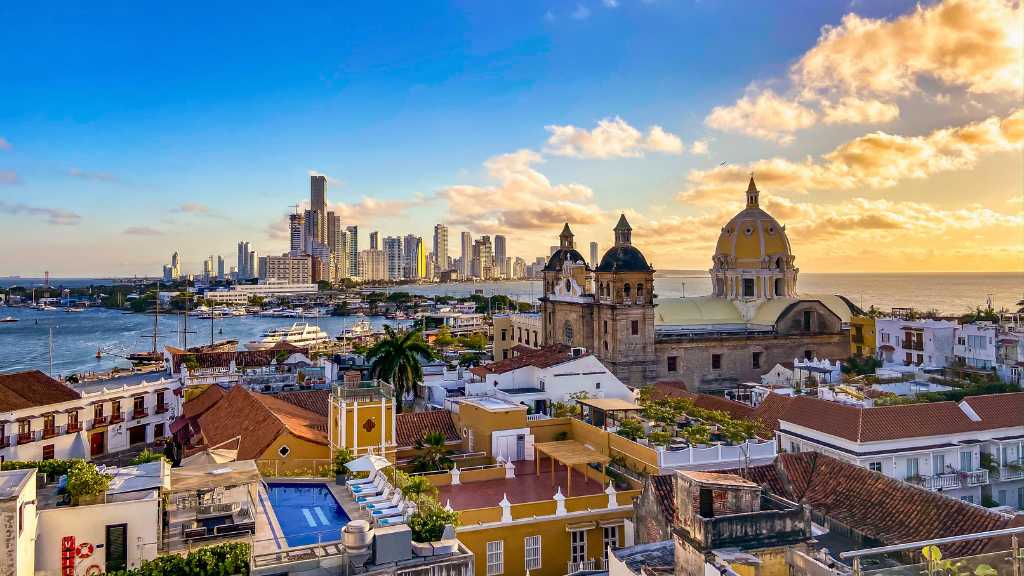 View over the rooftops of the historic centre and Church of Saint Peter Claver in Cartagena with the modern city of Bocagrande in the background.