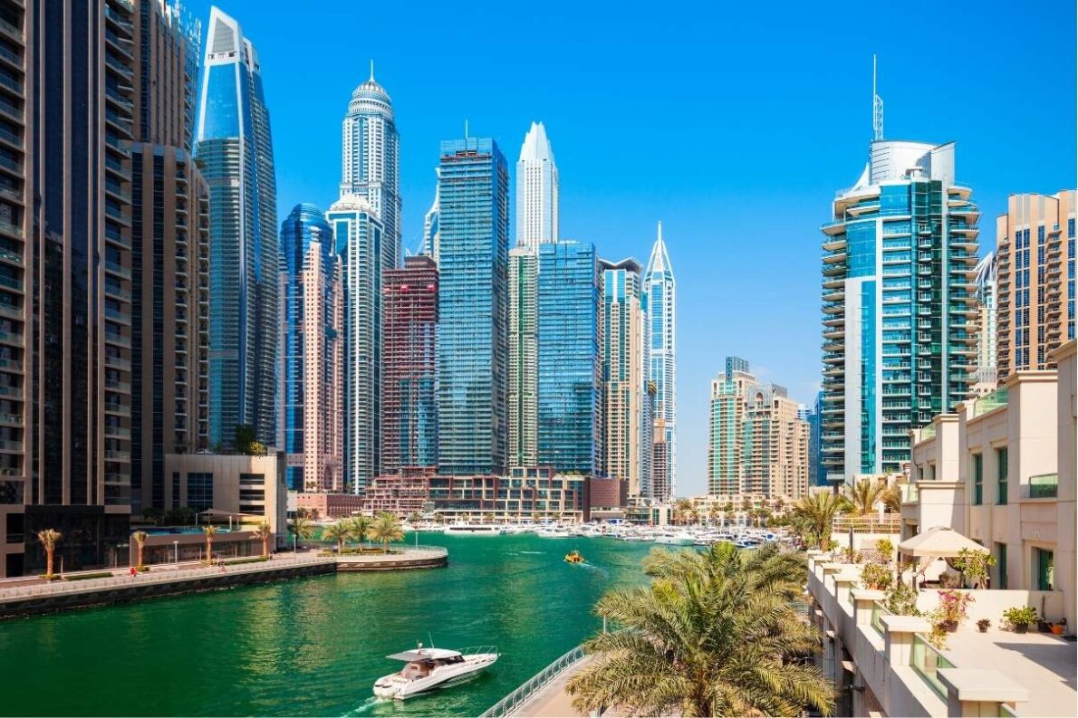 View of the artificial canal city, in Dubai, with tall buildings in the back.