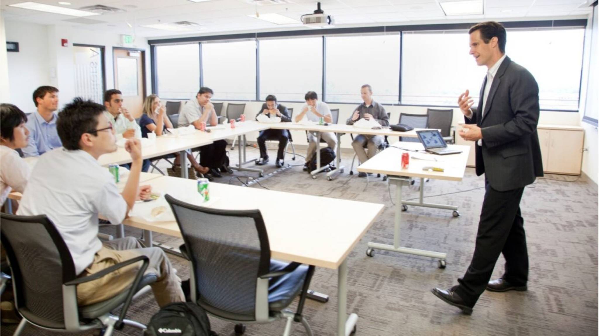 a teacher leading a group business English class.