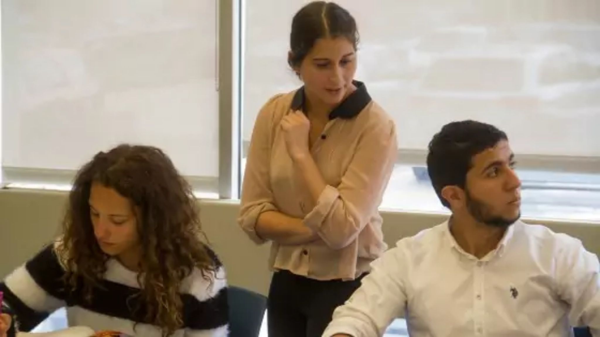 A teacher in class monitoring her students before erros correction