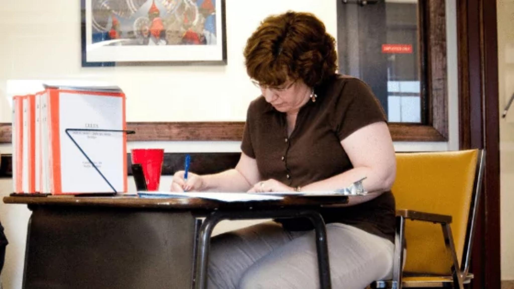 A teacher takling notes on her reflective journal